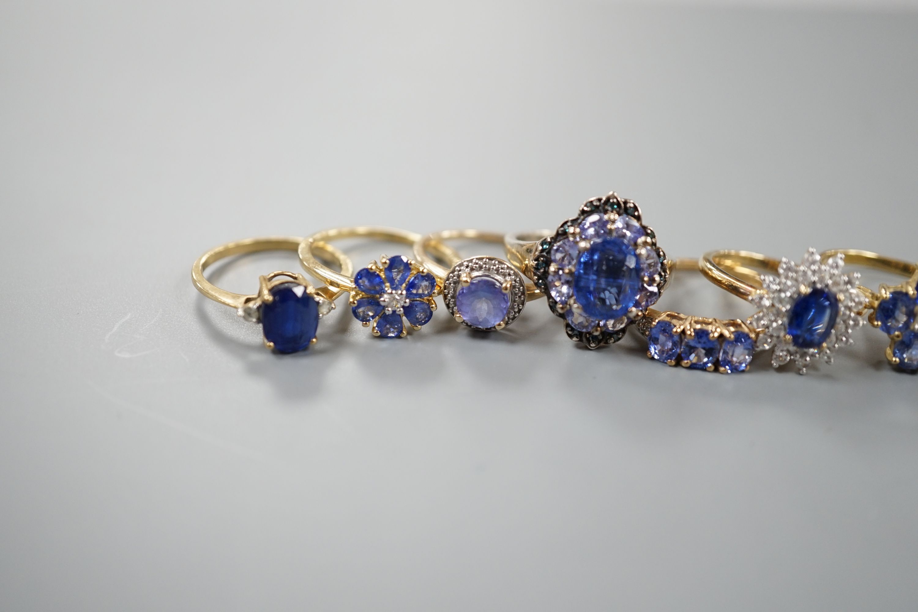 Eight assorted modern 9ct gold gem set rings, including opal doublet, gross 17.7 grams and a 925 ring.